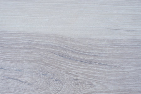 Close up of wooden surface in soft gray and beige tones with natural grain texture, suitable for backgrounds and interiors.の写真素材