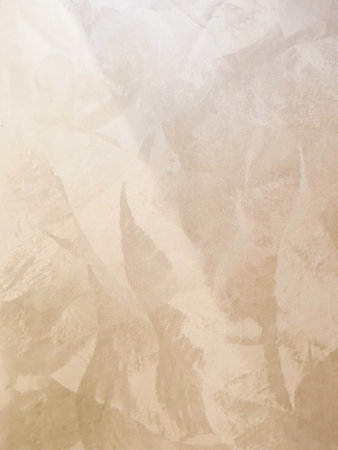 Elegant decorative plaster surface with soft light tones and artistic patterns, perfect for modern wall decoration and design projects.の写真素材