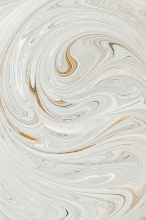 Abstract marble swirl in beige and white tones with elegant fluid curves, perfect for backgrounds, luxury branding, and modern design projects.の写真素材