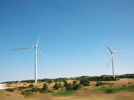 Wind turbine landscape in a field on a sunny summer dayの写真素材