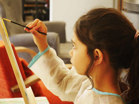 Close-up of a little girl paintingの写真素材