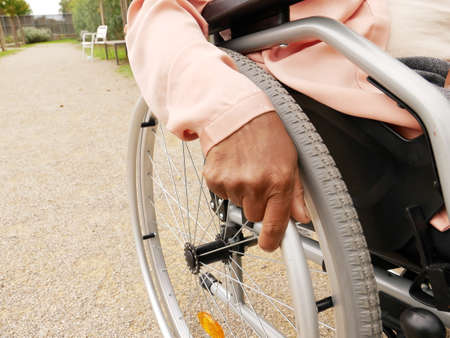 Close-up of the hand of a black woman pushing her wheelchairの写真素材