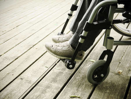 Close-up of the legs of a disabled woman in a wheelchair.の写真素材