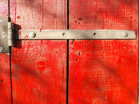 Photo of an old rustic and worn wood door painted redの写真素材