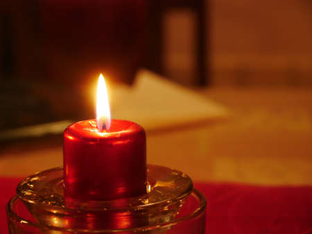Close-up on a lit candle to make a prayerの写真素材