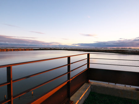 Photo taken from a terrace overlooking a pond during the sunset.の写真素材