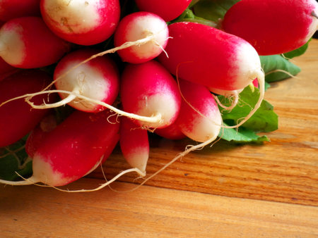 A closeup shot of red radish on a wooden tableの写真素材