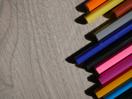 Photo of colored pencils on a wooden background for creative activities