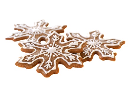 Gingerbread snowflake cookies decorated with white icing         の写真素材
