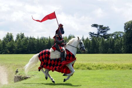 Knight riding a white horse holding a flagのeditorial素材