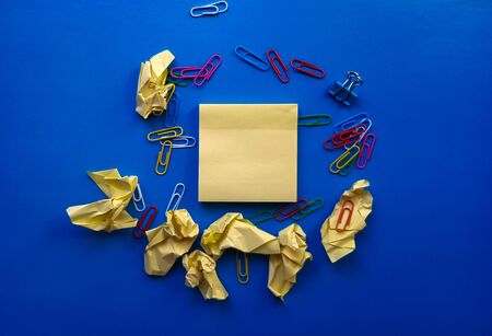 yellow sheet of paper for notes and paper clip.の写真素材