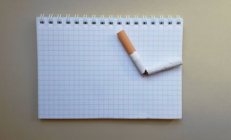 World No Tobacco Day, No Smoking Day. Broken cigarette on a business notebook, place for your text.の写真素材