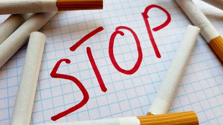 A sticker that says Stop is in a pack of cigarettes. World No Tobacco Day. Quit smoking. Fight with cigarettes.の写真素材