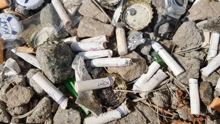 A lot of cigarette butts. The cause of lung cancer. Many used cigarette butts as trash.