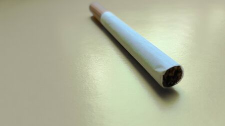 Cigarettes isolated diagonal on a yellow background.の写真素材