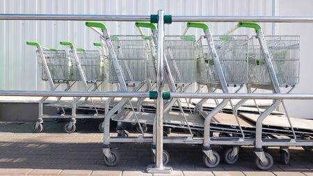 A shopping cart in a mall, used as a background image. A row of wheelbarrows for shopping at an...