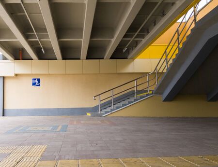 Ukraine, Kiev - September 26, 2019: The sign is an underground pedestrian crossing at the entrance to the underground passage. Empty yellow underground pedestrian crossing. Blue square transition sign in the city.のeditorial素材