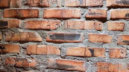Vintage brick wall background. The red clay brick is beautiful, strong,suitable for decoration as a folk wall, used as a background imageの写真素材