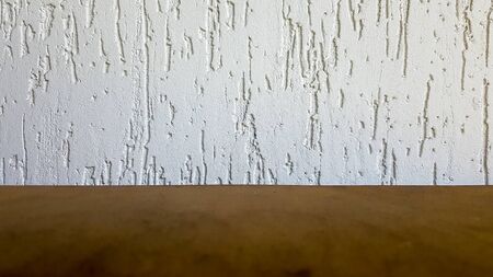 Empty top of a natural wooden table and retro white decorative wall. To display the product. Wooden...