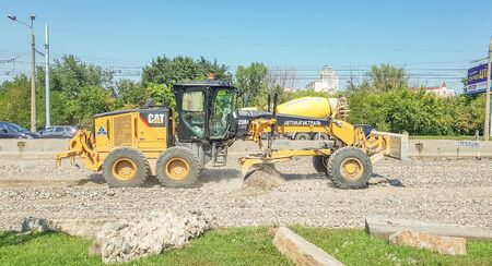 Ukraine, Kiev - October 1, 2019: Road roller, tractor and construction equipment are working on a...
