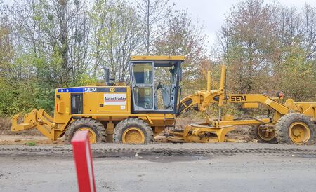 Ukraine, Kiev - October 1, 2019: Road roller, tractor and construction equipment are working on a...
