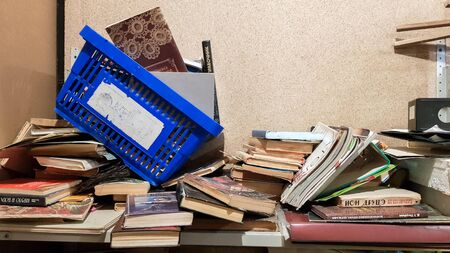 Ukraine, Kiev - October 10, 2019: many books are completely entangled in a heap. A mess in a store...