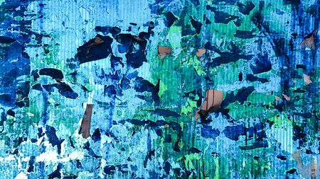 Uneven wavy plastic surface with the remains of flaky film and paper. Abstract obsolete blue...
