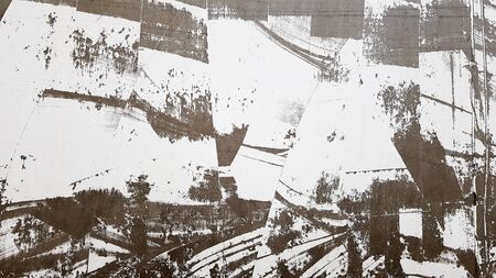 Weathered and aged concrete wall with paint, mostly peeled from black and white with vignetting....