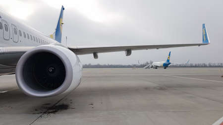 Ukraine, Borispol - March 27, 2020: engine turbine and wing of a large passenger plane awaiting...