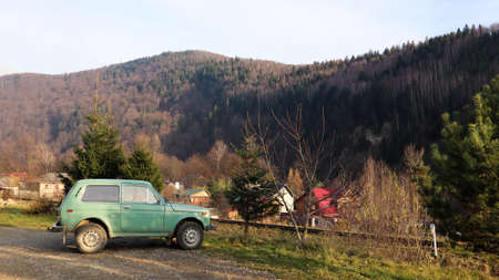 Ukraine, Yaremche - November 20, 2019. A jeep is parked with a mountain range in the background. The car is in the mountains of the Ukrainian Carpathians in the small town of Yaremcheのeditorial素材