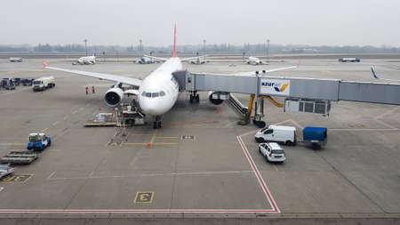 Ukraine, Borispol - March 27, 2020: a passenger plane with a boarding ladder and a jet bridge....
