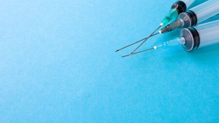 Three medical disposable plastic empty syringes with needles of different sizes and volumes....