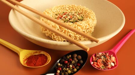 instant noodles with dry seasoning brown bowl, raw noodles. Vegetarian dish. Delicious Asian style dinner. pasta, for the preparation of which it is enough to pour boiling water and wait.の写真素材