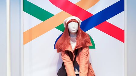 one woman mannequin in luxurious winter or autumn clothes in a shop window. A red-haired female mannequin demonstrates a casual collection of clothing. Brown coatの写真素材