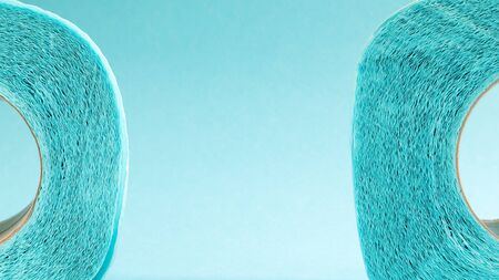 Blue roll of modern toilet paper on a blue background. A paper product on a cardboard sleeve, used for sanitary purposes from cellulose with cutouts for easy tearing. Embossed drawing. copy spaceの写真素材