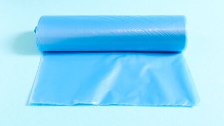 One roll of plastic garbage bags in blue on a blue background. Bags that are designed to accommodate...