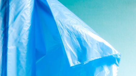 One roll of plastic garbage bags in blue on a blue background. Bags that are designed to accommodate...