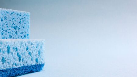 Two blue sponges on grey