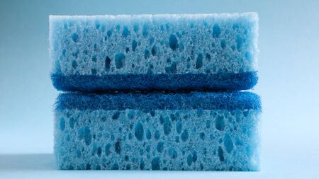 Two blue sponges used for washing and erasing dirt used by housewives in everyday life. They are made of porous material such as foam. Detergent retention, which allows you to spend it economically.の写真素材