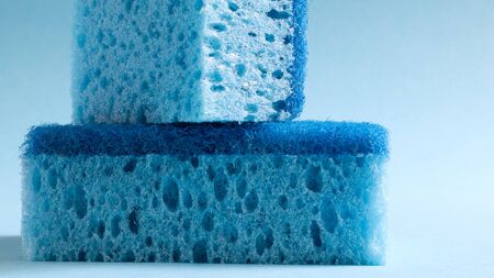 Two blue sponges used for washing and erasing dirt used by housewives in everyday life. They are...