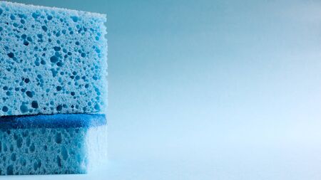 Two blue sponges used for washing and erasing dirt used by housewives in everyday life. They are...