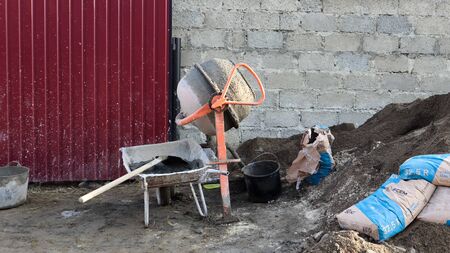 Gravity mobile concrete mixer with self-discharge orange color prepares cement mortar. Mobile...
