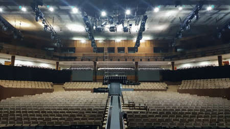 Ukraine, Kiev - June 9, 2020. Interior of an empty concert hall with beige seats and a balcony.