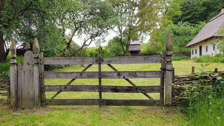 Closed wooden gate from the boards in the village or village. Vintage style designの写真素材