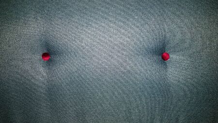 Closeup green textile sofa with buttons. Abstract background, upholstered furniture.