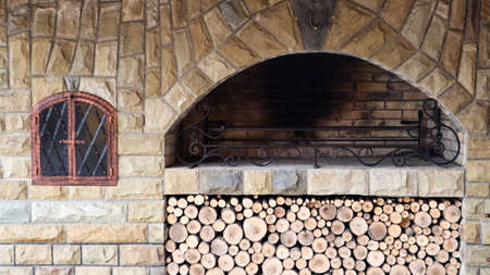Fire-resistant stone outdoor barbecue area with wood. Outdoor recreation area with barbecueの写真素材