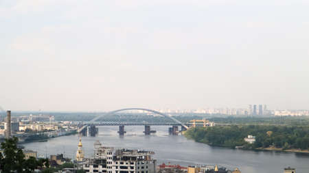 Top view of the old historical part of the city of Kiev. Vozdvizhenka area on Podol and the Dnieper river from the pedestrian bridge. Beautiful city landscape. Ukraine, Kiev - September 6, 2020のeditorial素材
