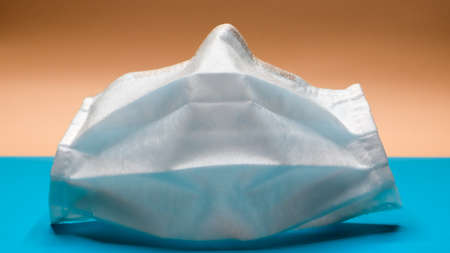 One 3-layer disposable surgical face mask with rubber pads to cover the mouth and nose. The concept...