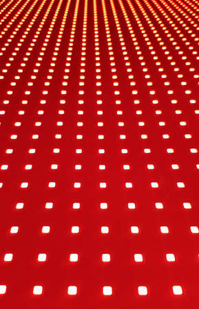 RGB LED screen panel texture. Close-up of a pixel LED screen with bokeh for wallpaper. Bright red...