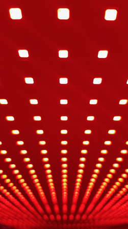 RGB LED screen panel texture. Close-up of a pixel LED screen with bokeh for wallpaper. Bright red...